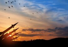Drone War Escalation: Odesa Devastated Silhouette of missiles against a colorful sunset with birds flying