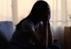 Brain Drama: Is Overthinking Making You Sick? A silhouette of a person sitting with their head in their hands, conveying distress
