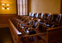 NFL Star’s Stunning Verdict: What Happens Now? Empty jury box with wooden chairs in a courtroom