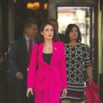 MISSING JFK FILES: A New CIA Scandal? Woman in a bright pink suit walking out of a building