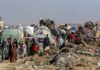 Gaza Chaos Erupts — Cameras Stayed Off? Displaced families with belongings crowd a rubble-strewn road