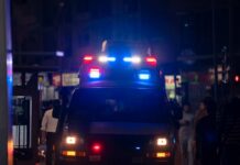 CHILLING: Rural Call Escalates to Fatal Exposure Emergency vehicle with flashing lights in a busy urban area at night