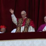 Pope waving from a balcony during a public address