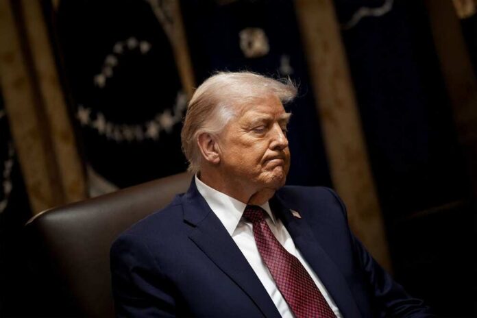 President,Donald,Trump,Announces,$12,Billion,Farm,Aid,Package,During A political figure seated with a serious expression in a formal setting