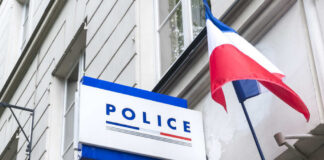 Sign for a police station with a French flag