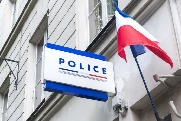 shutterstock_625846166.jpg Sign for a police station with a French flag