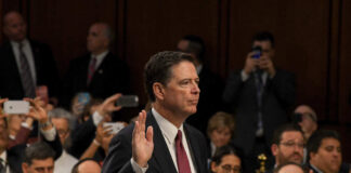 A man raising his right hand during a congressional hearing