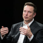 A business leader speaking during an interview, using hand gestures for emphasis