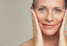 Sunscreen Rankings Exposed: Comfort Beats Hype Close-up portrait of a smiling woman gently holding her face