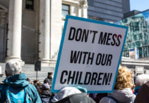 Parents Score Surprise Supreme Court Win A protester holding a sign that reads 'DON'T MESS WITH OUR CHILDREN!'