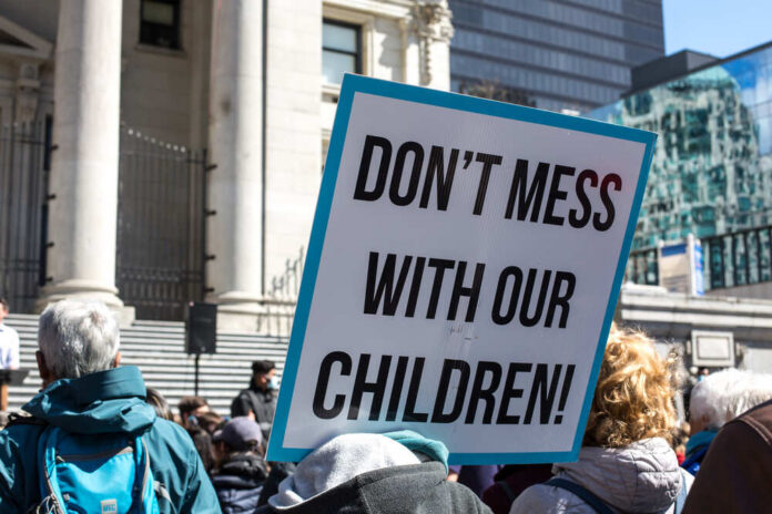 Vancouver,,Bc,,Canada,,04.10.2021,A,Sign,Don't,Mess,With,Our A protester holding a sign that reads 'DON'T MESS WITH OUR CHILDREN!'