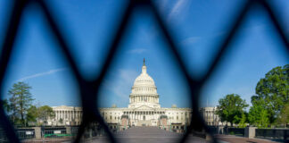 View of the U.S. Capitol building through a security fence