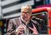 Pride Parade Revolt Stuns Schumer A man in a blazer speaking passionately at a podium with a microphone