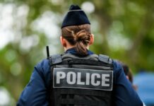 Gruesome Belfast Attack Sparks Border Uproar Back view of a police officer wearing a uniform and a police vest