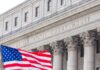 High Court Slams Door — NYC Pushes Back Facade of a United States courthouse with an American flag in the foreground