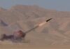 Ceasefire Chaos: Missiles Fly Anyway A missile launching into the sky with smoke and flames in a desert setting