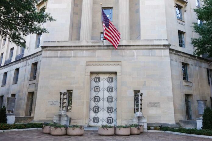 Department,Of,Justice,Building,-,Washington,D.c.,United,States,Of Facade of a government building featuring the American flag and decorative entrance