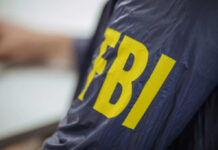 FBI Nabs Alleged UFC Attack Mastermind Close-up of an FBI agents jacket with yellow lettering
