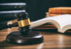 Vigilante Sting Chaos Rattles Florida Courts Judge's gavel on desk with open law book