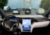 EU Puts Cameras In Every New Car Car interior with large touchscreen showing navigation on a busy highway