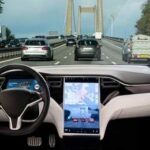 EU Puts Cameras In Every New Car Car interior with large touchscreen showing navigation on a busy highway