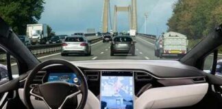Car interior with large touchscreen showing navigation on a busy highway