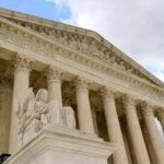 Supreme Court building with columns and statue