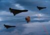 Missile Barrage Rattles Saudi Border Three military drones fly through a cloudy sky amid anti-air fire