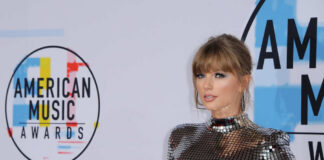 A celebrity posing on the red carpet at the American Music Awards