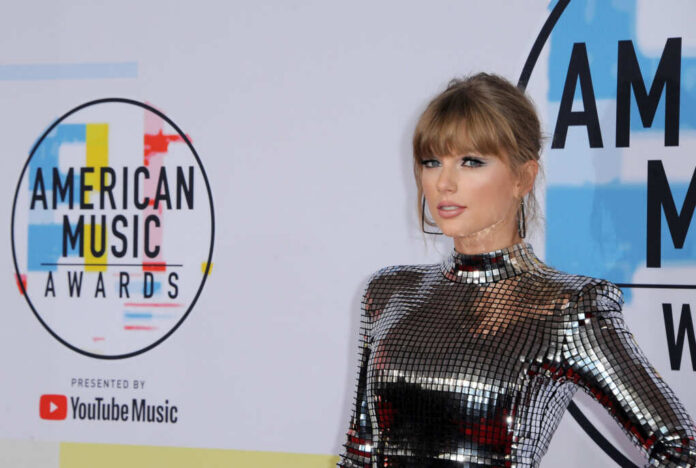A celebrity posing on the red carpet at the American Music Awards