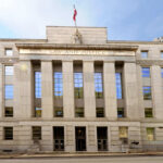 Spyware Titans Dragged Into Court Facade of a government building with the words Law and Justice and a statue on top