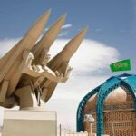 missile launcher beside domed building with green flag