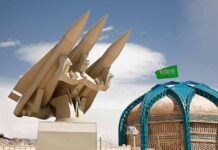 missile launcher beside domed building with green flag
