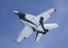 Fighter jet banking in clear sky