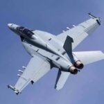 Fighter jet banking in clear sky