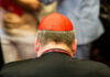 Top Cardinal Steps Back After Shocking Claims Back view of a cardinal wearing a red zucchetto and black attire