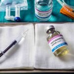 Medical tray with syringe and pentobarbital vials on gauze
