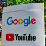 Google and YouTube logos on an outdoor office sign