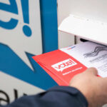 Election Drag Stokes California Firestorm Person placing a mail-in ballot into a voting drop box