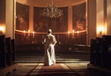Schism Erupts: Bishops Banished Overnight A religious figure standing in a church with candlelight and historic artwork