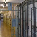 Prison corridor with barred doors