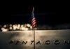 Pentagon’s Push-Button Mines Spark Panic A small American flag positioned in front of the word 'PENTAGON' on a reflective surface