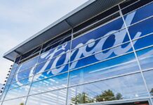 EV Dream Dies: Ford Slams the Brakes Exterior view of a Ford dealership with a large logo on the glass