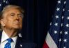 Exit Or Rebrand? Iraq Deal Sparks Fury A political figure looking upward beside an American flag