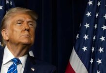 Exit Or Rebrand? Iraq Deal Sparks Fury A political figure looking upward beside an American flag