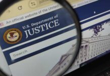 Federal Power Play Targets State Elections Close-up view of the U.S. Department of Justice website through a magnifying glass