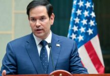 Rubio’s Terror Gambit Sparks Global Backlash Marco Rubio speaking at a podium with an American flag in the background