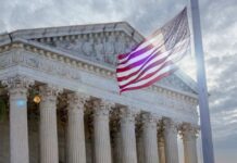 Supreme Court Slams Door — NCAA Shrugs The Supreme Court building with an American flag waving in front