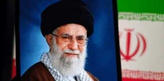 Portrait of a political leader with a black turban and glasses