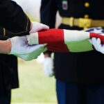 Military personnel folding a flag during a ceremonial event